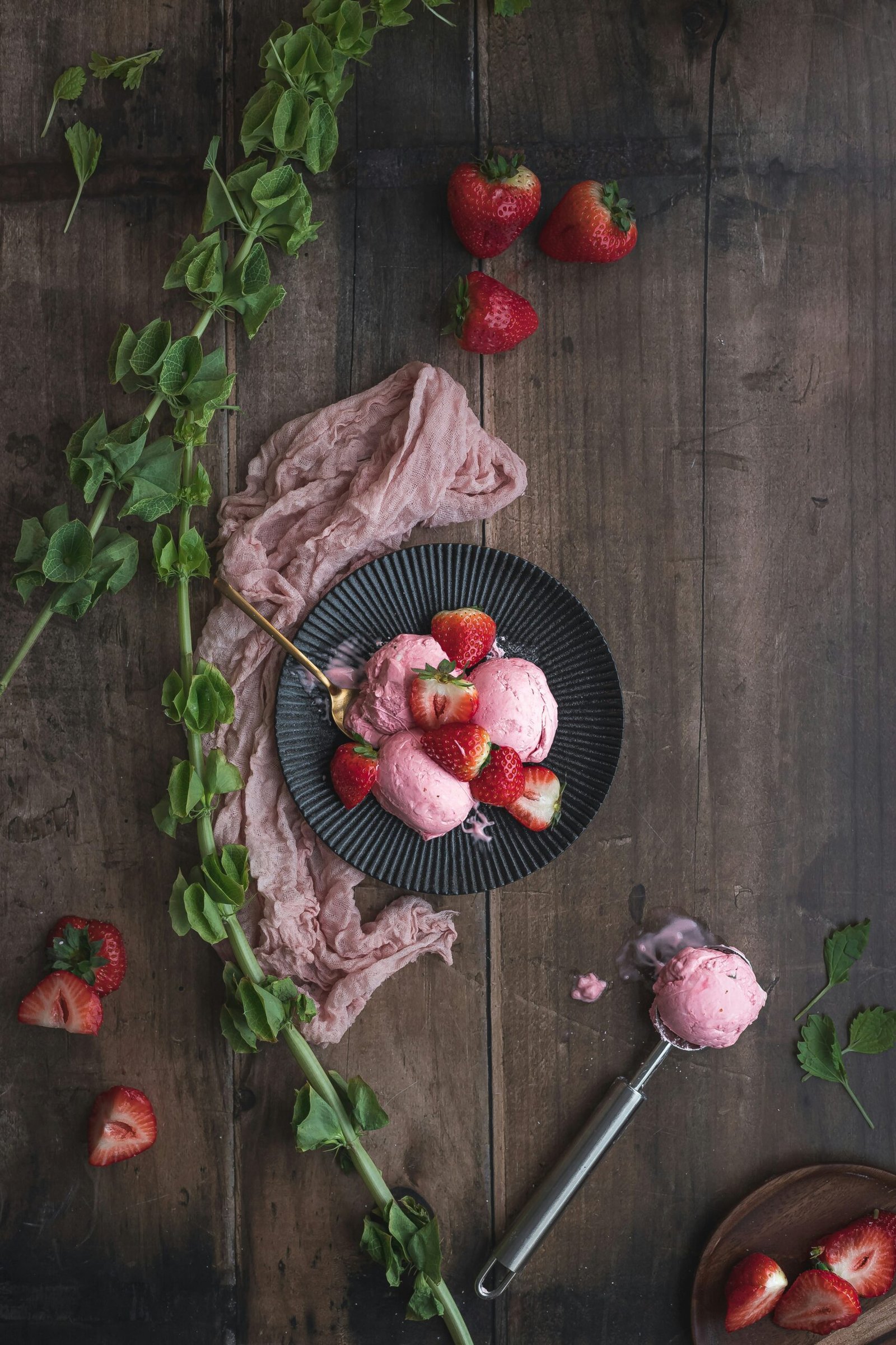red strawberries on black ceramic bowl